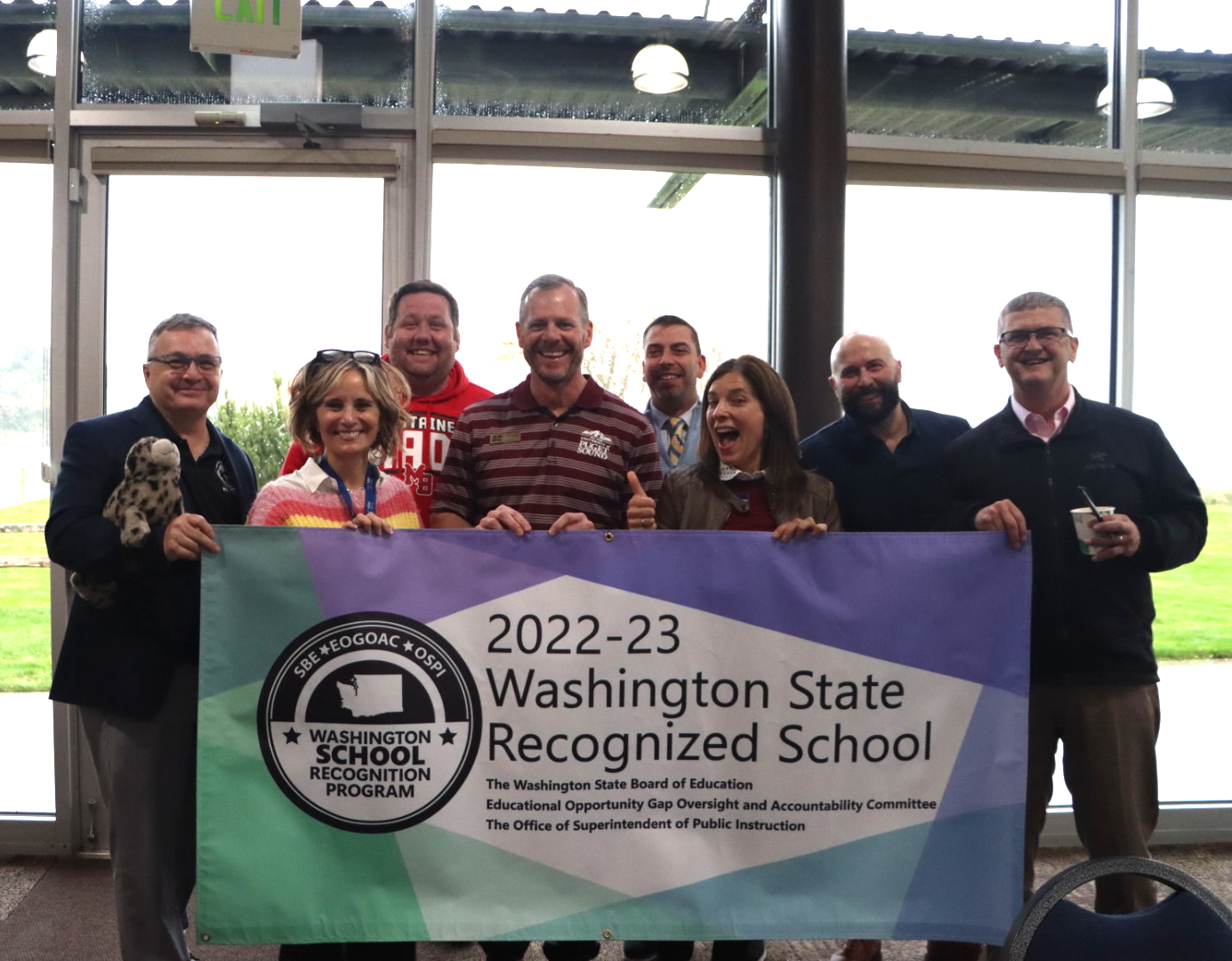 Superintendents from Northwest ESD 189 pose with a recognition banner at a meeting in Anacortes on Nov. 1.