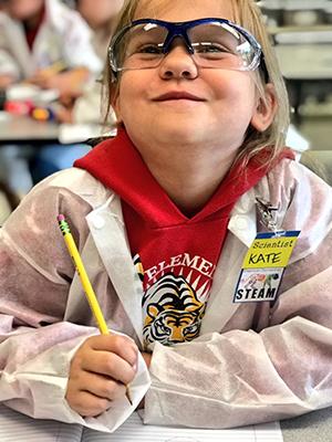 Sherman STEAM student smiling in lab with goggles